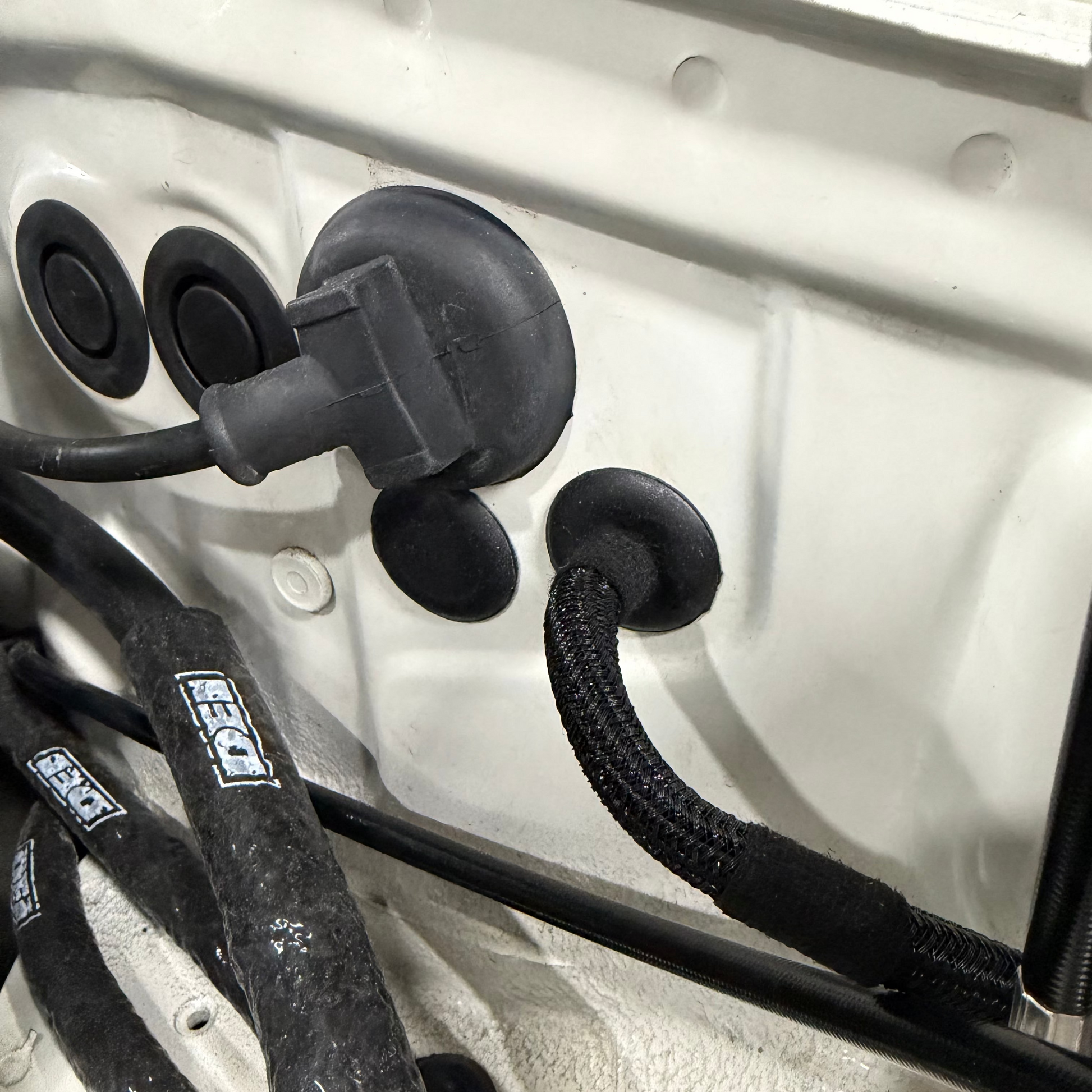 SaikoMFG Miata throttle cable firewall plug close-up
