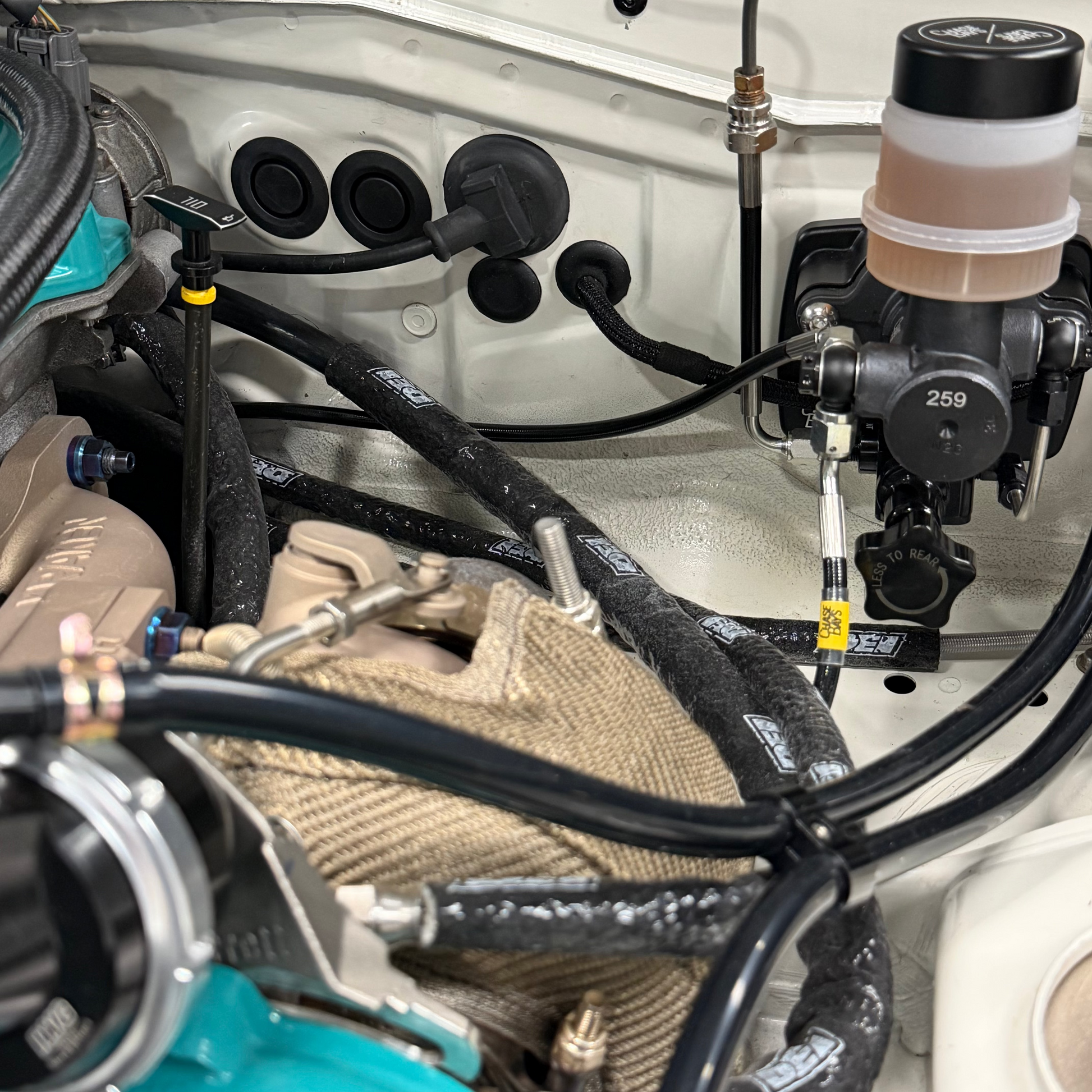 Miata throttle cable delete plug installed in firewall
